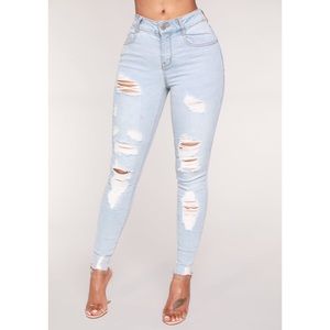Fashion Nova High waisted distressed jeans.